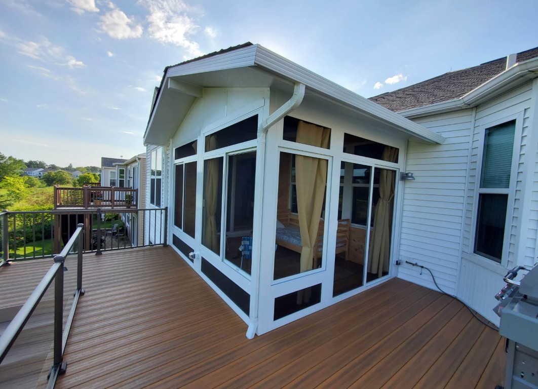 Screen room addition on wooden deck with mesh panels
